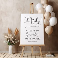 an easel with balloons and a welcome sign for a baby shower is shown in front of a backdrop