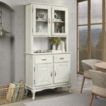 a white china cabinet sitting next to a dining room table