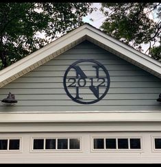 the roof of a house with a clock on it's side and numbers painted in black