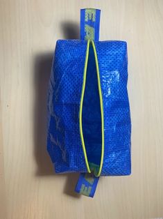 a blue bag sitting on top of a wooden table