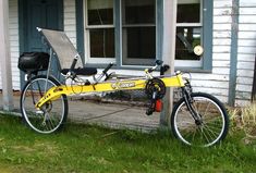 a yellow bicycle parked in front of a house