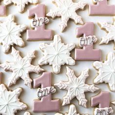 decorated cookies with frosting and icing are arranged in the shape of snowflakes