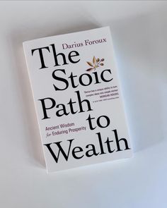 the stoic path to wealth book sitting on top of a white table with black lettering