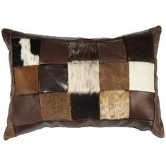 a brown and white patchwork pillow on a white background