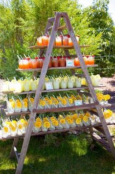 a wooden stand with orange juices and lemonade cups on it's sides