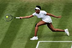 a tennis player in mid air after hitting the ball with his racket on a grass court