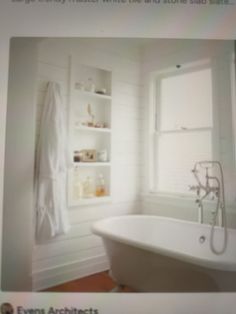 a white bath tub sitting next to a window