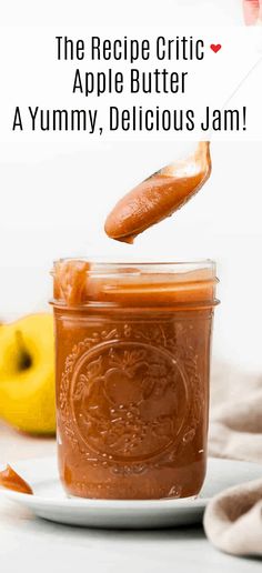 a jar filled with apple butter on top of a white plate