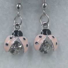 These Light Pink Lady Bug Earrings are made with 2 silver, pink and black painted lady bugs and 2 cubic zirconia gems in the centers!  So super cute Pink Metal Earrings With Rhinestones, Cute Pink Metal Earrings, Bug Earrings, Lady Bugs, Pink Lady, Woman Painting, Lady Bug, Pink And Black, Cute Jewelry