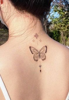 a woman with a butterfly tattoo on her back