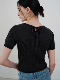 This is a comfortable and trendy top by ourcomos that is made out of high quality cotton and acrylic blend fabric. With refined design detail with trendy look, it will stand out from your casual and feminine daily outfit.- Round neckline with ribbon on the back- Subtle shirring detail- Light and cool touch of cotton blend knit Black Pointelle Knit V-neck Top, Black Fine Knit Fitted Top, Black Fitted Knit Top With Ribbed Neckline, Fitted Black Knit Top With Ribbed Neckline, Black Fine Knit Tops For Summer, Black Crew Neck Top With Pointelle Knit, Fine Knit Black Top For Summer, Summer Fine Knit Black Tops, Black Fitted Cotton Blouse