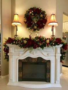 a decorated fireplace with wreaths and lights