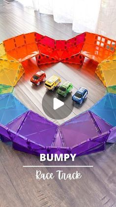 a rainbow colored play structure with toy cars in it and the words bumpy race track