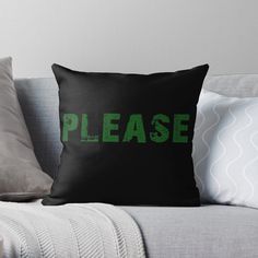 a black and green pillow sitting on top of a couch