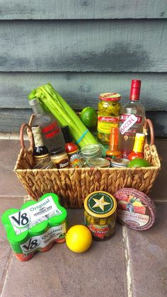 a basket filled with lots of different types of food and condiments next to a wall