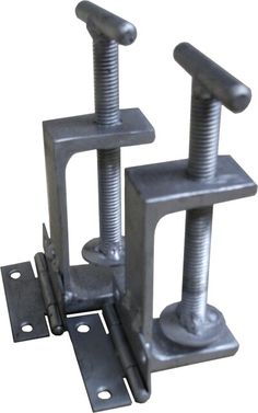 two metal brackets with screws on each side and one is holding an object in the middle