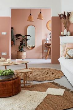 a living room with pink walls and rugs