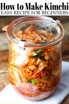 a glass jar filled with food sitting on top of a white napkin next to a wooden table