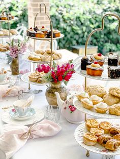 a table topped with lots of different types of pastries and desserts on top of plates