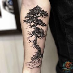 a man's arm with a tree tattoo on it