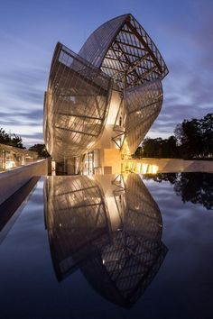 a building that is sitting on top of a body of water in front of it