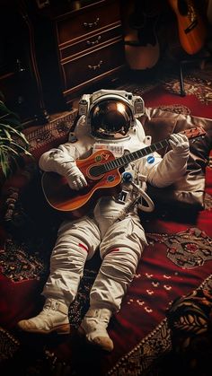 an astronaut is sitting on the ground with a guitar in his lap and wearing a space suit