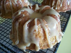 there is a bundt cake with icing on the cooling rack