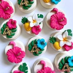 there are many decorated cupcakes with flowers on them