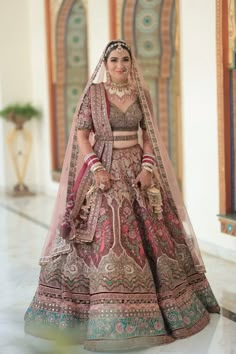 a woman in a bridal gown posing for the camera