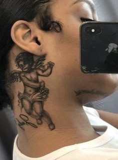 a woman with a tattoo on her neck taking a selfie in front of a mirror