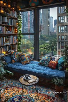 a living room filled with lots of books and furniture next to a window covered in plants