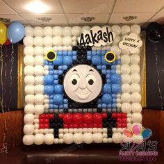 a thomas the train balloon wall with balloons on it's sides and an air filled birthday