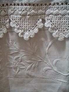 an embroidered piece of cloth with flowers on it