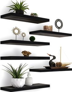 three floating shelves with plants and vases on them, each shelf has a different type of decoration