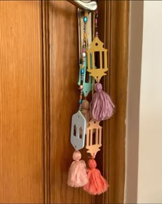 a door handle with some tassels hanging from it's side and on the outside