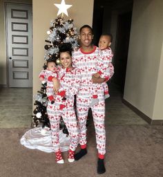 a man and two women in matching christmas pajamas