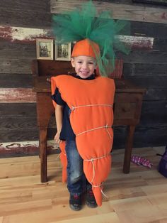 a young boy dressed up as a carrot