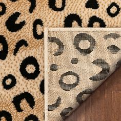 an animal print rug on top of a wooden floor