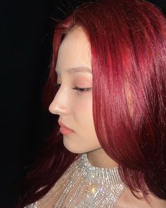 a woman with red hair wearing a silver dress