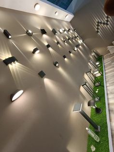 the interior of a modern building with grass and lights