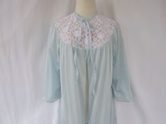 Vintage 1970s/1980s Style / Title: Lacy Gathered Maxi Long Tie Neck Open Front Silky Nylon Nightgown Robe Pockets Feminine Retro Color: Light Blue w/White Lace Size: Women's Medium /Large No: #GGVCWPRR34 Approx. Year: 1970's/1980's Made: USA? Brand / Designer: N/A Labels / Tags: N/A, Size Label: N/A Main Material: Nylon (exclusive of decorations) Texture / Pattern: Semi-Sheer Silky Stretchy Soft Nylon Color: Blue w/White Lace Shape / Style: Feminine Lacy Gathered Maxi Long Tie Neck Open Front Nightgown Robe Collar / Neckline: Pretty Lacy Round Tie Neckline Front Design: Comfortable Gathered Front/Back Design Closure: Two Fabric Straps Front Neck Closure w/Open Front Sleeve: Comfortable Gathered Semi-Raglan Robe 3/4 Sleeve Pocket: Practical Two Side Front Pockets Trim: Lovely White Sheer Fl Nightgown Robe, 1980s Style, Style Feminine, Elegant Feminine, 1980s Fashion, Vintage Glam, Womens Robes, Retro Color, Tie Neck