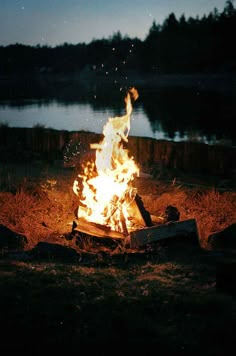 a campfire is lit up in the dark