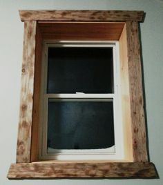 a wooden window frame hanging on the wall