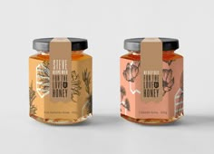 three honey jars with labels on them sitting side by side in front of a white background