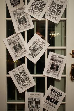 a bunch of newspapers are hanging on the front door to read what they think about them