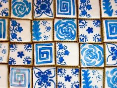 blue and white tiles are arranged in the shape of squares with flowers on them