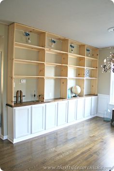 a living room filled with lots of wooden shelves