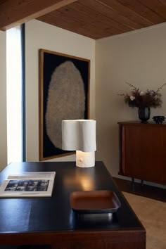 a table with a lamp and pictures on it