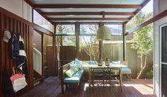 a patio with wooden flooring and furniture