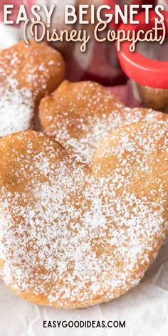 some sugary heart shaped pastries sitting on top of paper